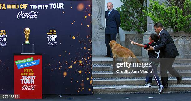 Mexican President's son Luis Felipe Calderon Zavala attempts to grab the trophy during the tour of the FIFA World Cup trophy at the Official...