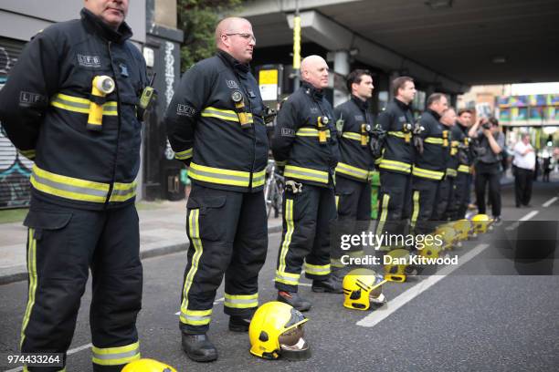 Firefighters line the street during a silent march to St Marks Park where an open Iftar will take place on the one year anniversary of the Grenfell...