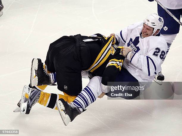 Steve Begin of the Boston Bruins tackles Colton Orr of the Toronto Maple Leafs in the third period on March 4, 2010 at the TD Garden in Boston,...