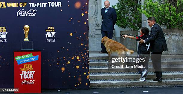 Mexican President's son Luis Felipe Calderon Zavala attempts to grab the trophy during the tour of the FIFA World Cup trophy at the Official...