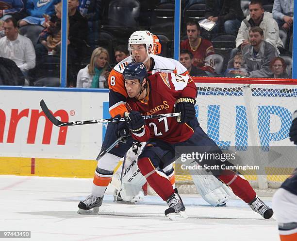 Chris Thorburn of the Atlanta Thrashers battles for position against Jack Hillen of the New York Islanders at Philips Arena on March 4, 2010 in...