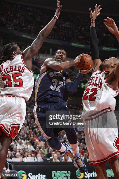 Mayo of the Memphis Grizzlies drives to the basket against Chris Richard and Taj Gibson of the Chicago Bulls on March 4, 2010 at the United Center in...