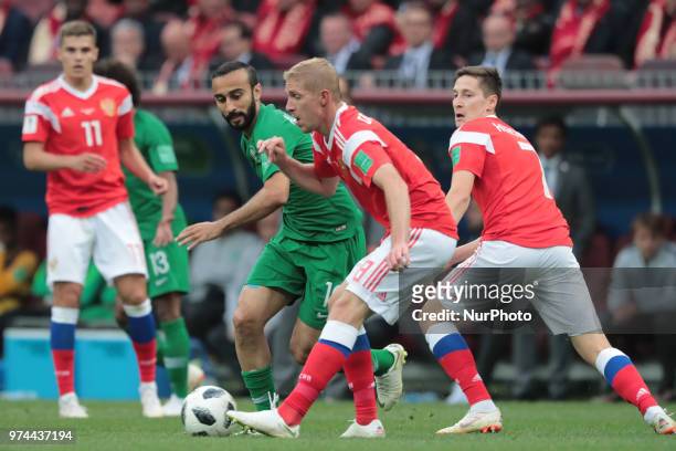Forward Mohammed Alsahlawi of Saudi Arabia National team and midfielder Iury Gazinsky of Russia National team during the Group A match between Russia...