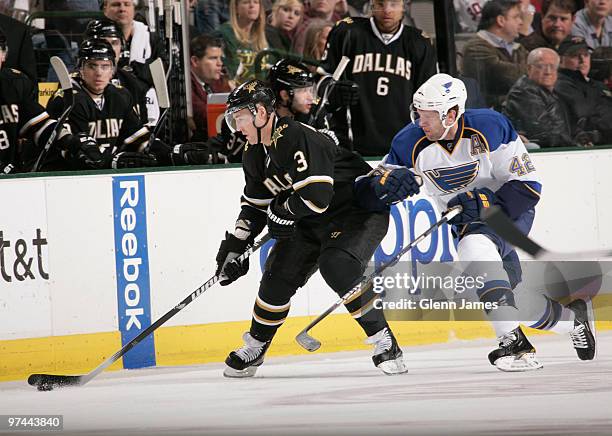 Stephane Robidas of the Dallas Stars tries to keep the puck away against David Backes of the St. Louis Blues on March 4, 2010 at the American...