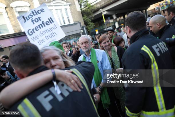 Leader of the Labour Party, Jeremy Corbyn greets firefighters during a silent march on the one year anniversary of the Grenfell Tower fire on June...