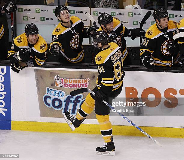 Mirslav Satan of the Boston Bruins is congratulated by teammates Steve Begin,Vladimir Sobotka and Dennis Wideman after he scored the game winner...