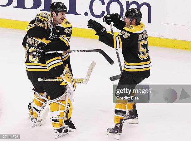 Tim Thomas and Mark Stuart and Johnny Boychuk of the Boston Bruins celebrate the win over the Toronto Maple Leafs on March 4, 2010 at the TD Garden...