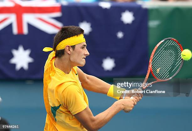 Bernard Tomic of Australia plays a backhand in his match against Tsung-Hua Yang of Chinese Taipei during day of the Davis Cup Asia-Oceania Zone Group...