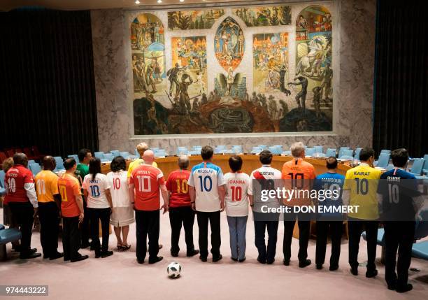 Members of the Security Council pose for photos wearing World Cup uniforms June 14, 2018 at the United Nations in New York.