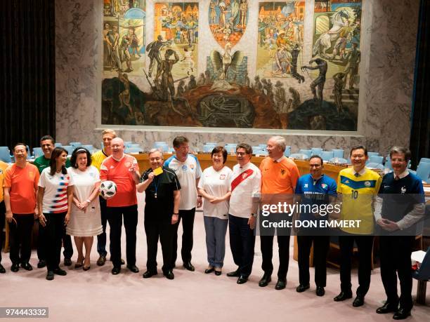 Secretary General António Guterres pulls out a yellow card as members of the Security Council pose for photos wearing World Cup uniforms June 14,...