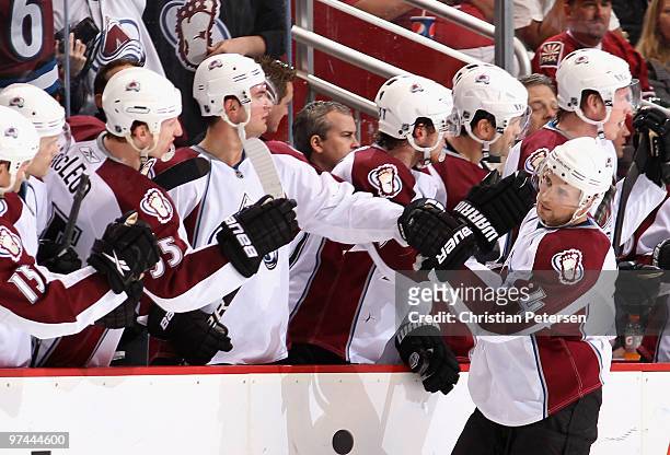 John-Michael Liles of the Colorado Avalanche celebrates with teammates on the bench after scoring a second-period power-play goal against the Phoenix...