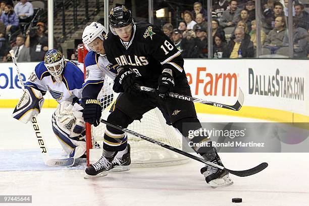 Left wing James Neal of the Dallas Stars skates the puck against Jay McClement of the St. Louis Blues at American Airlines Center on March 4, 2010 in...