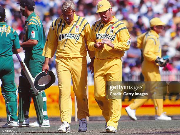 Shane Warne and Allan Border of Australia plan tactics during a One Day International match between Australia and South Africa on January 21, 1994 in...