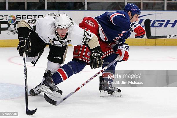 Sidney Crosby of the Pittsburgh Penguins collides with Dan Girardi of the New York Rangers on March 4, 2010 at Madison Square Garden in New York...