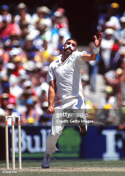 Merv Hughes of Australia bowls during a Test match in Australia.
