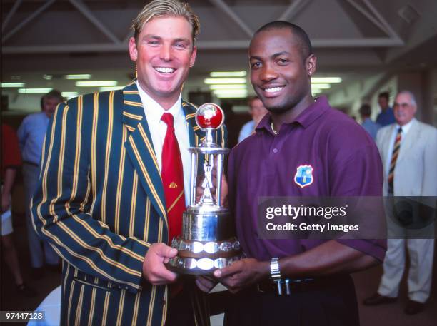 Shane Warne of Australia and Brian Lara of the West Indies poses with a trophy in Australia.