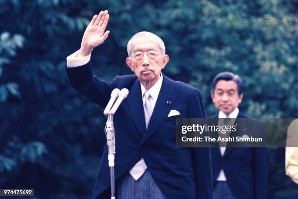 Emperor Hirohito waves to guests during the spring garden party at the Akasaka Imperial Garden on May 19, 1988 in Tokyo, Japan.