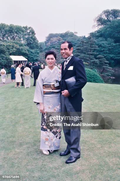 Former baseball player Sachio Kinugasa and his wife Masako pose for photographs during the spring garden party at the Akasaka Imperial Garden on May...