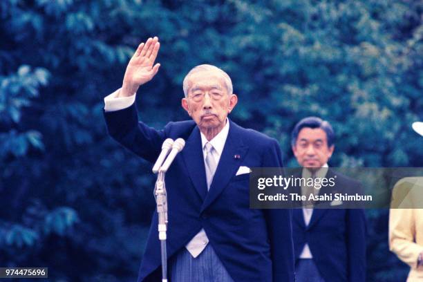 Emperor Hirohito waves to guests during the spring garden party at the Akasaka Imperial Garden on May 19, 1988 in Tokyo, Japan.