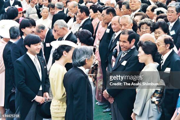 Crown Prince Akihito and Crown Princess Michiko talk with former baseball player Sachio Kinugasa during the spring garden party at the Akasaka...