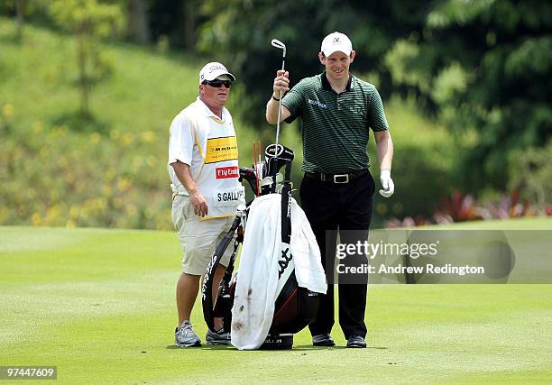 Stephen Gallacher of Scotland waits with his caddie on the 17th hole during the the second round of the Maybank Malaysian Open at the Kuala Lumpur...