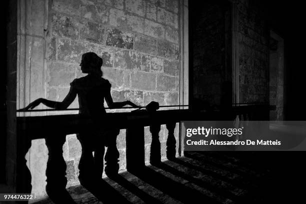 shadow silhouette of woman, palazzo risolo, specchia, apulia, italy - ballustrade stockfoto's en -beelden