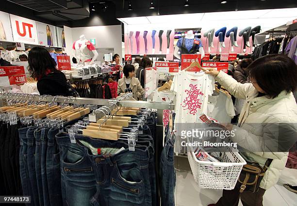 Customers shop at a Fast Retailing Co. Uniqlo store in Tokyo, Japan, on Friday, March 5, 2010. Fast Retailing Co., Japan's largest clothing retailer,...