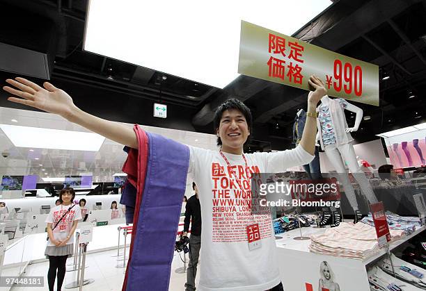 An employee greets customers at a Fast Retailing Co. Uniqlo store in Tokyo, Japan, on Friday, March 5, 2010. Fast Retailing Co., Japan's largest...