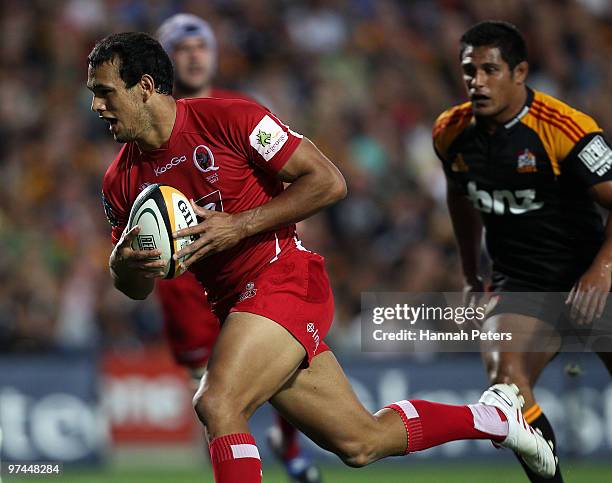 Will Chambers of the Reds on his way to score during the round four Super 14 match between the Chiefs and the Reds at Waikato Stadium on March 5,...