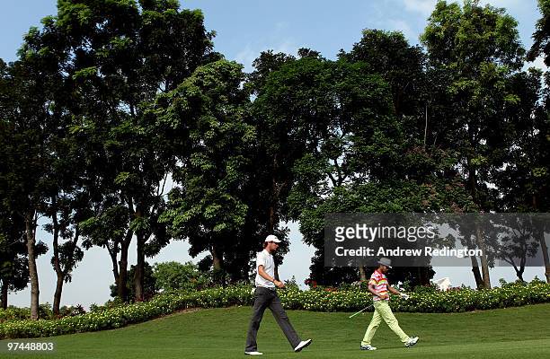 Chris Wood of England and Shingo Katayama of Japan walk together on the 16th hole during the the second round of the Maybank Malaysian Open at the...