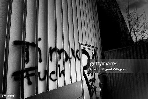 Flashlight illuminates the writing 'Tim K Fuck' on the wall of an aluminum company next to the parking lot where Tim Kretschmer died on March 4, 2010...