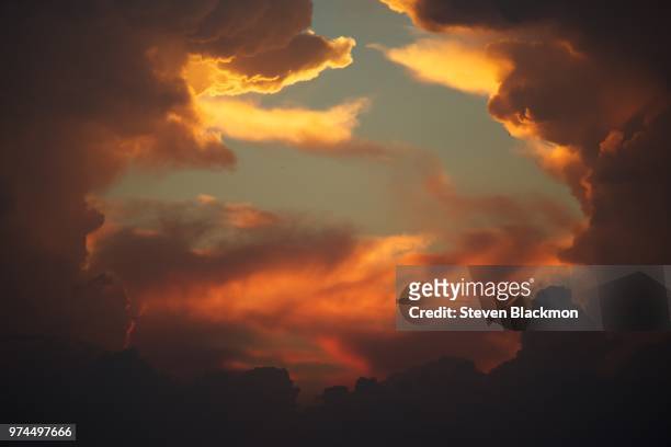 dramatic sky at sunset, new orleans, louisiana, usa - inferno stock-fotos und bilder