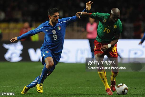 Marco Borriello of Italy battles for the ball with Stephane Mbia of Cameroon during the International Friendly match between Italy and Cameroon at...