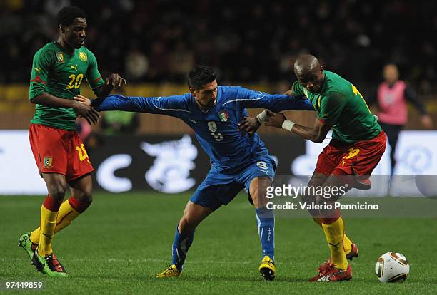 Marco Borriello of Italy battles for the ball with Stephane Mbia and Georges Mandjeck of Cameroon during the International Friendly match between...