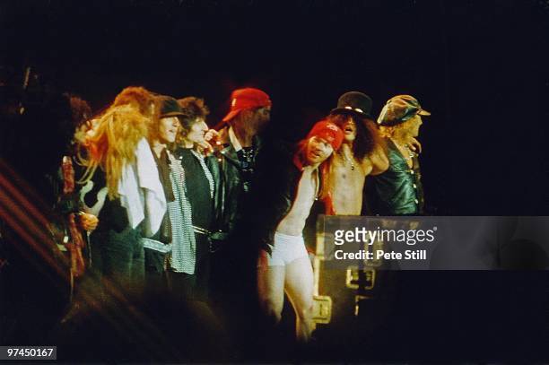 Members of Guns n' Roses including Axl Rose and Slash are joined by Rolling Stones guitarist Ronnie Wood while taking their final bow after...