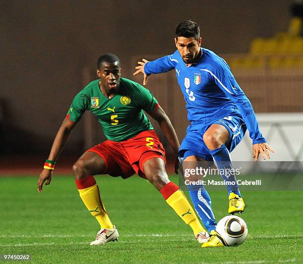 Marco Borriello of Italy battles for the ball against Sebastien Bassong of Cameroon during the International Friendly match between Italy and...