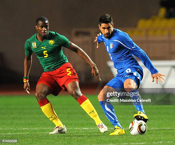 Marco Borriello of Italy battles for the ball against Sebastien Bassong of Cameroon during the International Friendly match between Italy and...