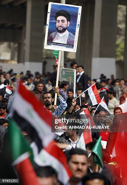 Supporters wave Iraqi flags at a campaign rally for Ammar al-Hakim, head of the Supreme Islamic Iraqi Council , which is part of the broad Shiite...