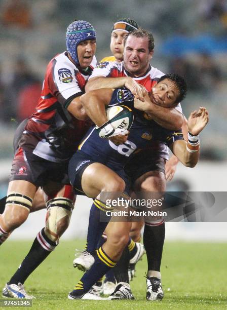 Christian Lealiifano of the Brumbies is tackled during the round four Super 14 match between the Brumbies and the Lions at Canberra Stadium on March...
