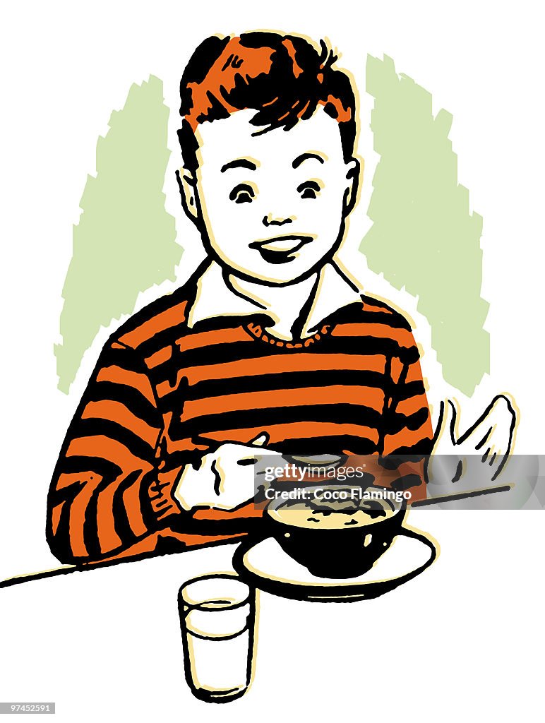 A young boy enjoying his dinner