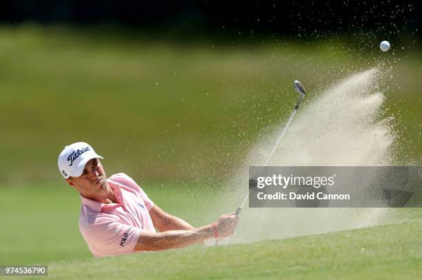 Justin Thomas of the United States plays his second shot on the second hole with his caddie Michael Greller during the first round of the 2018 US...