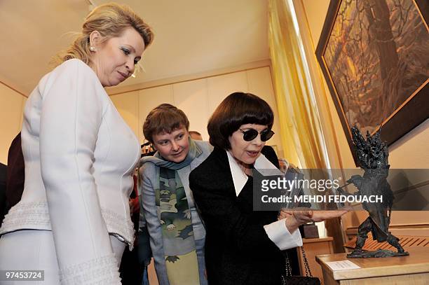 Russian first lady Svetlana Medvedeva listens to French singer Mireille Mathieu as they visit the exhibition called "A window to Russia" on March 2,...