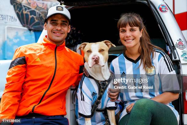 Argentina Fans who have been traveling for 32 months, Tomy and Mariana, and their dog Draco pose for a picture on June 14, 2018 in Moscow, Russia....
