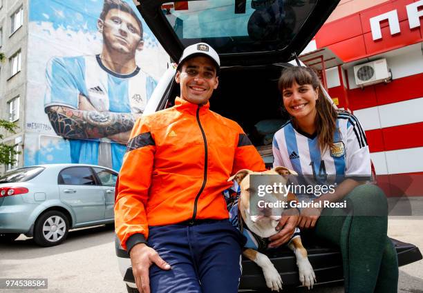 Argentina Fans who have been traveling for 32 months, Tomy and Mariana, and their dog Draco pose for a picture on June 14, 2018 in Moscow, Russia....