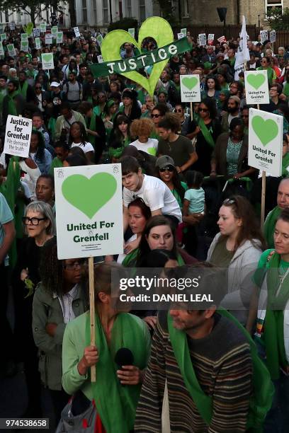 Members of the public take part in a silent march as part of commemorations on the first anniversary of the Grenfell fire in west London on June 14,...