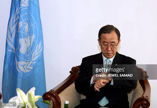 Secretary General Ban Ki-moon checks the time as he waits for a meeting with Australia's Prime Minister Kevin Rudd before the start of the high-level...