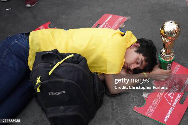 Football fan sleeps off the excitement at the official FIFA Fan Fest at Moscow State University to watch the first World Cup game between Russia and...