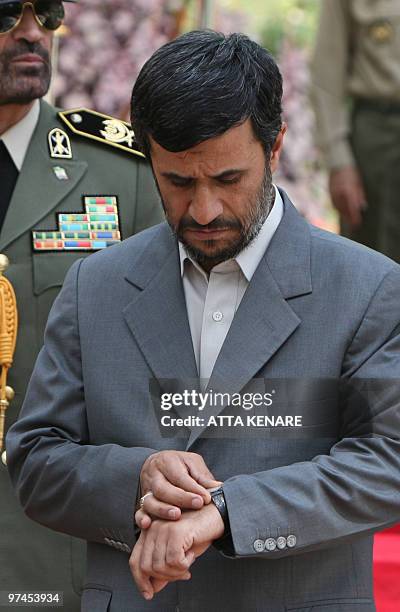 Iranian President Mahmoud Ahmadinejad waits for the arrival of his Algerian counterpart President Abdelaziz Bouteflika at the presidential palace in...