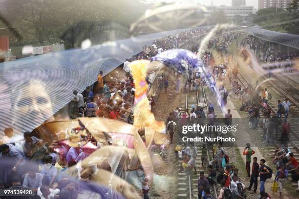 Bangladeshi people wait for trains at a railway station to go their homes to celebrate upcoming Eid-al-Fitr festival in Dhaka, Bangladesh on June 14,...