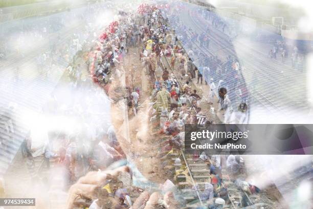 Bangladeshi people wait for trains at a railway station to go their homes to celebrate upcoming Eid-al-Fitr festival in Dhaka, Bangladesh on June 14,...